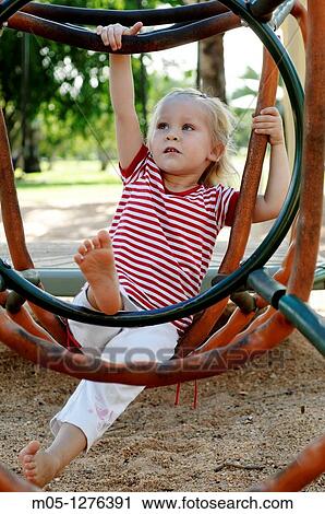 Three years old toddler playing at the playground View Large Photo Image Stock Image - Three years old toddler playing at the playground. Fotosearch