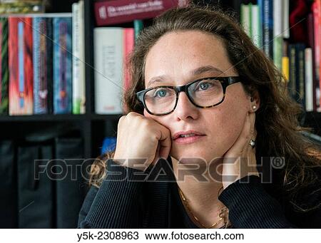 Tilburg, Netherlands. Young, single, and thoughtful woman with her library of books. View Large Photo Image Stock Image - Tilburg, Netherlands. Young, single, and thoughtful woman with her library of books.. Fotosearch