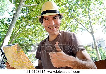Stock Photography - Tourist looking at map. Fotosearch