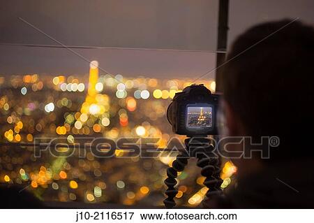 Tourist photo of Eiffel Tower, night, from Tour Montparnasse, Paris, France View Large Photo Image Stock Photo - Tourist photo of Eiffel Tower, night, from Tour Montparnasse, Paris, France. Fotosearch