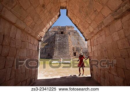 Stock Photography - Tourist walking around the Pyramid of the Magician, Maya archeological site Uxmal, Yucatan, Mexico, Central America.. Fotosearch