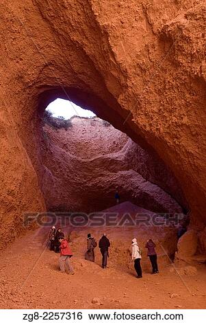Stock Photograph - Tourists visiting a wide cave at Las Medulas Natural Park, a former Romane gold mine, Unesco World Heritage List, El Bierzo, Leon, Castilla y Leon, Spain. Fotosearch