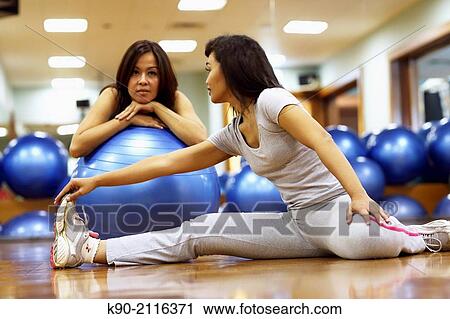 Two asian women doing excercises while one laying on the floor, Jakarta, Indonesia, Southeast Asia. View Large Photo Image Stock Image - Two asian women doing excercises while one laying on the floor, Jakarta, Indonesia, Southeast Asia.. Fotosearch
