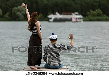 Two young men on the riverbank. View Large Photo Image Picture - Two young men on the riverbank.. Fotosearch