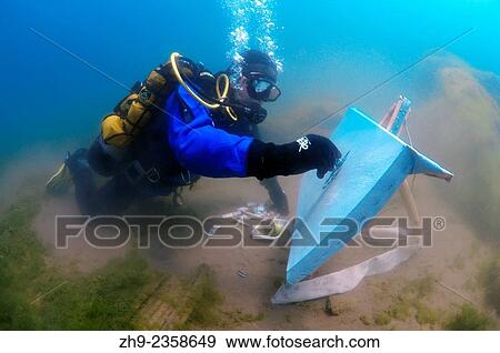 Stock Photo - Underwater artist Yuriy Alexeev (Yuri Alekseev) paints a picture under water. Lake Baikal, Listvyanka, Irkutsky District, Irkutsk Oblast, Siberia, Russia, Eurasia.. Fotosearch