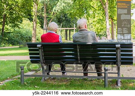 West-Berlin, Berlin, Germany. Two elder and retired men talking en enjoying eich others company on a bench at the UNESCO site Schiller Park. View Large Photo Image Stock Photograph - West-Berlin, Berlin, Germany. Two elder and retired men talking en enjoying eich others company on a bench at the UNESCO site Schiller Park.. Fotosearch