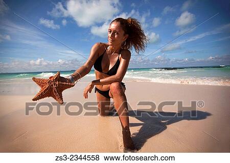 Woman holding a starfish on the beach, Isla Mujeres, Cancun, Quintana Roo, Yucatan Province, Mexico, Central America. View Large Photo Image Stock Photo - Woman holding a starfish on the beach, Isla Mujeres, Cancun, Quintana Roo, Yucatan Province, Mexico, Central America.. Fotosearch