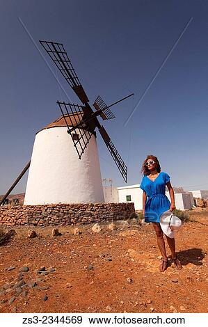 Woman posing in front of the windmill near Antigua, Fuerteventura, Canary Islands, Spain, Europe. View Large Photo Image Stock Photo - Woman posing in front of the windmill near Antigua, Fuerteventura, Canary Islands, Spain, Europe.. Fotosearch