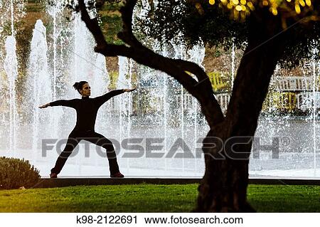 Woman practicing Yoga, Riera Park, Palma, Mallorca, Balearic Islands, Spain. View Large Photo Image Stock Image - Woman practicing Yoga, Riera Park, Palma, Mallorca, Balearic Islands, Spain.. Fotosearch
