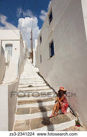 Woman sitting at the stairs in Apollonia village, Sifnos, Cyclades Islands, Greek Islands, Greece, Europe. View Large Photo Image Picture - Woman sitting at the stairs in Apollonia village, Sifnos, Cyclades Islands, Greek Islands, Greece, Europe.. Fotosearch