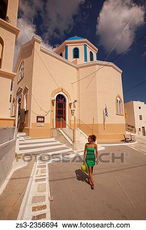 Woman walking around a colorful church in Hora, Serifos, Cyclades Islands, Greek Islands, Greece, Europe. View Large Photo Image Picture - Woman walking around a colorful church in Hora, Serifos, Cyclades Islands, Greek Islands, Greece, Europe.. Fotosearch