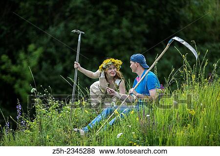 Young couple with an agricultural tool in the field. View Large Photo Image Stock Photo - Young couple with an agricultural tool in the field.. Fotosearch
