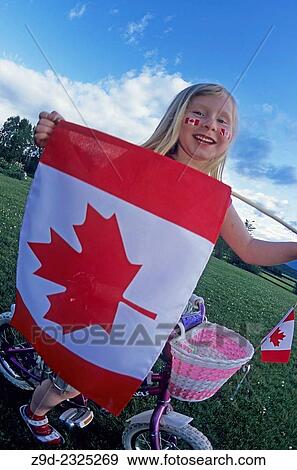 Young girl celebrating Canada Day holiday with Canada flag. View Large Photo Image Stock Photo - Young girl celebrating Canada Day holiday with Canada flag.. Fotosearch