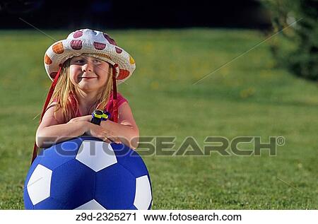Young girl in garden portrait leaning on ball. View Large Photo Image Stock Image - Young girl in garden portrait leaning on ball.. Fotosearch