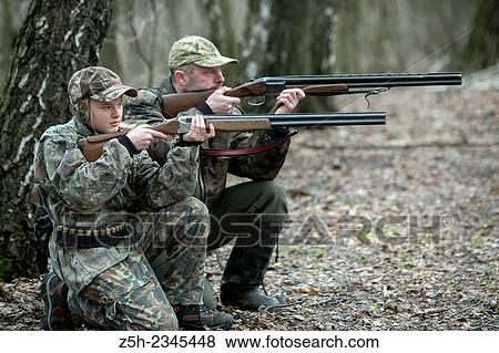 Young girl on the hunt with an experienced instructor in the forest. View Large Photo Image Stock Photo - Young girl on the hunt with an experienced instructor in the forest.. Fotosearch