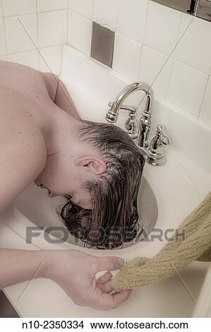 Young woman washing her hair. View Large Photo Image Picture - Young woman washing her hair.. Fotosearch