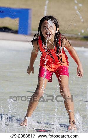 A little girl playing in the water at a water park. View Large Photo Image Stock Photo - A little girl playing in the water at a water park.. Fotosearch