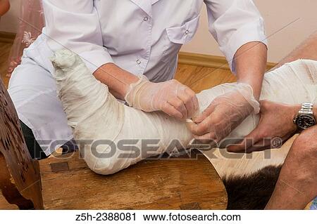 A man with a broken leg. Paramedic and patient. View Large Photo Image Stock Image - A man with a broken leg. Paramedic and patient.. Fotosearch