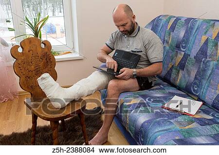 A man with a foot injury. View Large Photo Image Picture - A man with a foot injury.. Fotosearch