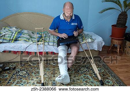 Stock Photograph - A man with a foot injury.. Fotosearch