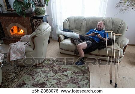 Stock Photograph - A man with a foot injury.. Fotosearch