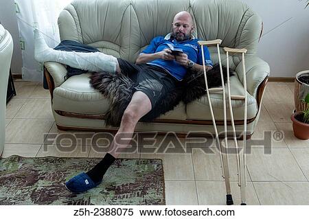 Stock Photography - A man with a foot injury.. Fotosearch