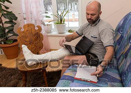 Stock Photography - A man with a foot injury.. Fotosearch