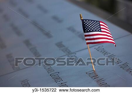 "A small American flag left on the names inscribed in the perimeter of one of the pools at the National September 11 Memorial in New York City, New York, USA" View Large Photo Image Stock Image - "A small American flag left on the names inscribed in the perimeter of one of the pools at the National September 11 Memorial in New York City, New York, USA". Fotosearch