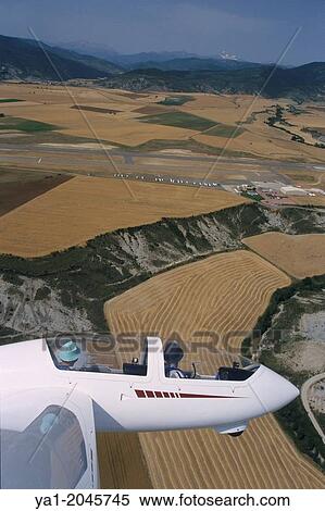 "Aerial view of glider plane Twin Astir flying over aerodrome of Santa Cilia de Jaca, Aragon, Spain. " View Large Photo Image Stock Photography - "Aerial view of glider plane Twin Astir flying over aerodrome of Santa Cilia de Jaca, Aragon, Spain. ". Fotosearch