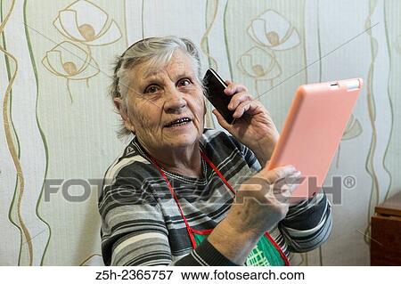 Stock Photo - "An elderly woman, a lover of computer games. ". Fotosearch