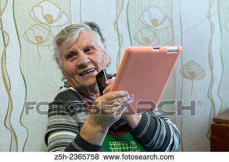 "An elderly woman, a lover of computer games. " View Large Photo Image Stock Photo - "An elderly woman, a lover of computer games. ". Fotosearch