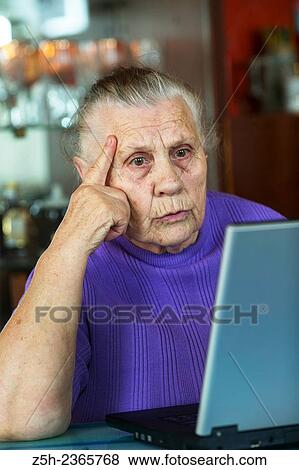 Stock Photo - "An elderly woman, a lover of computer games. ". Fotosearch