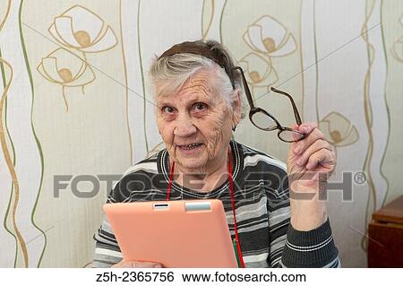 Stock Photograph - "An elderly woman, a lover of computer games. ". Fotosearch