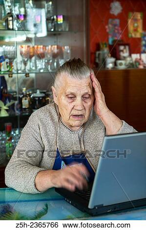 Stock Photograph - "An elderly woman, a lover of computer games. ". Fotosearch