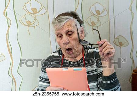 Stock Photography - "An elderly woman, a lover of computer games. ". Fotosearch
