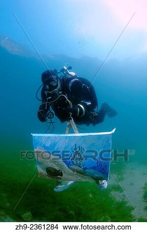 Picture - "Assistant artist swims with the picture painted by the water, the artist Underwater artist Yuriy Alexeev (Yuri Alekseev). Lake Baikal, Listvyanka, Irkutsky District, Irkutsk Oblast, Siberia, Russia, Eurasia. ". Fotosearch