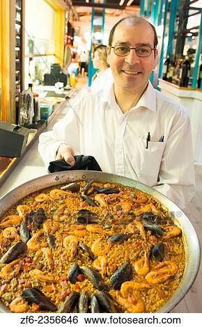 Stock Photograph - Barcelona Spain tapasCosta Gallega Tapas Restaurant counter waiter restaurant food bar plate serve.. Fotosearch