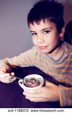 Stock Image - Boy eating. Fotosearch