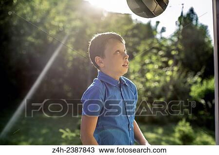 Stock Image - Boy playing with a ball.. Fotosearch