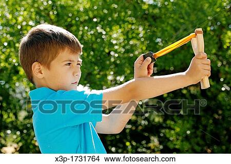 Picture - Boy with a slingshot. Fotosearch