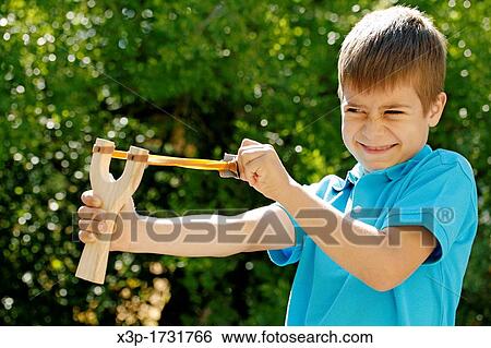 Boy with a slingshot View Large Photo Image Stock Photograph - Boy with a slingshot. Fotosearch