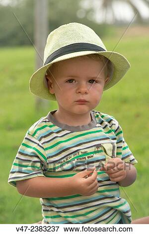 Child in hat looking at camera seriously View Large Photo Image Stock Photo - Child in hat looking at camera seriously. Fotosearch