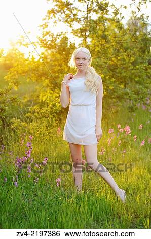 Close-up of a young woman at sunset. View Large Photo Image Stock Photograph - Close-up of a young woman at sunset.. Fotosearch