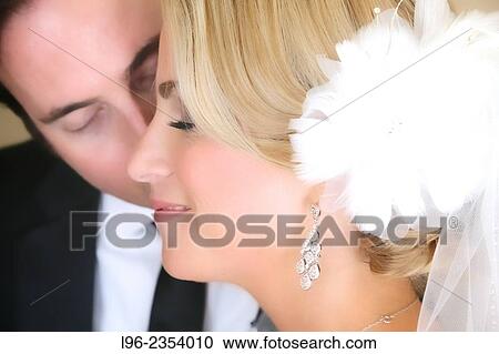 close-up of groom kissing his happy bride on cheek View Large Photo Image Stock Image - close-up of groom kissing his happy bride on cheek. Fotosearch