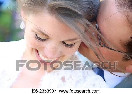 "close-up on happy couple embracing, enjoying a private moment after their wedding" View Large Photo Image Stock Photo - "close-up on happy couple embracing, enjoying a private moment after their wedding". Fotosearch