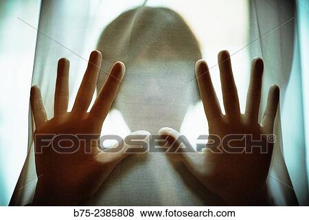 "Closeup of a hands on position of attention and pressure with the silhouette of a woman in the background, behind a transparent curtain. " View Large Photo Image Stock Photo - "Closeup of a hands on position of attention and pressure with the silhouette of a woman in the background, behind a transparent curtain. ". Fotosearch