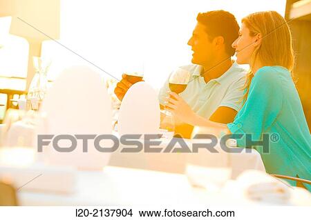 Picture - Couple in outdoor restaurant. Fotosearch
