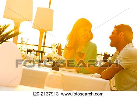 Stock Image - Couple in outdoor restaurant. Fotosearch
