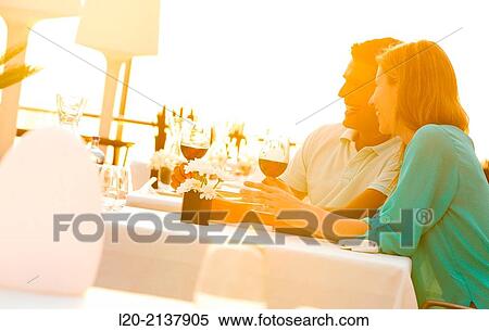 Stock Photography - Couple in outdoor restaurant. Fotosearch