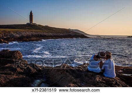 "Couple in Punta Herminia gardens, in background Tower of Hercules, Roman lighthouse, Coruña city, Galicia, Spain. " View Large Photo Image Stock Photo - "Couple in Punta Herminia gardens, in background Tower of Hercules, Roman lighthouse, Coruña city, Galicia, Spain. ". Fotosearch